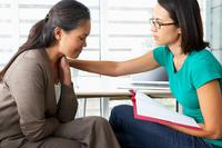 Female counselor providing therapy to woman